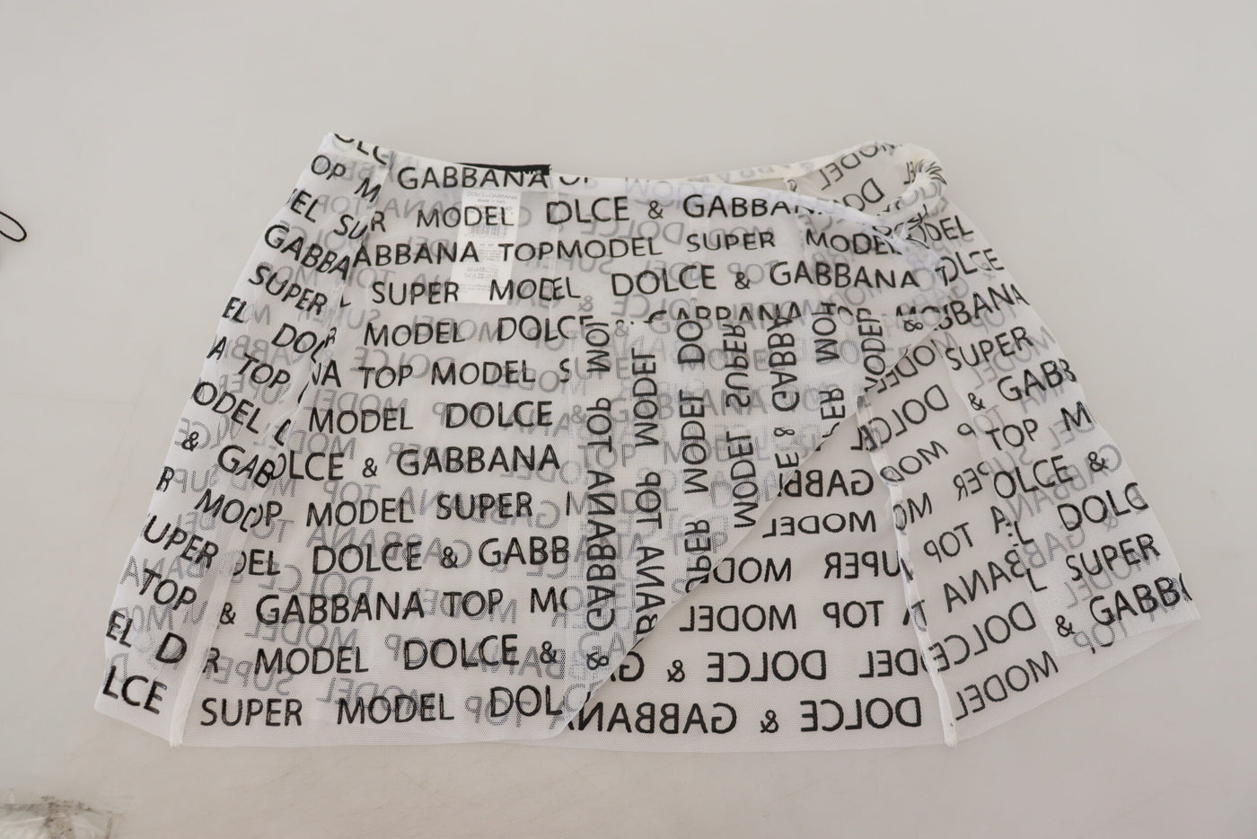 Mini-jupe trapèze transparente à logo blanc Dolce &amp; Gabbana